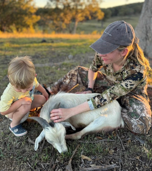 Sammy Grodecki holding Chester in the bush at dusk