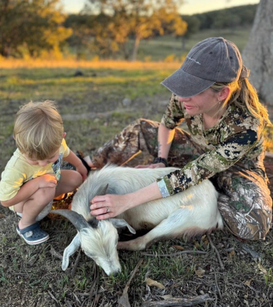 Sammy Grodecki holding Chester in the bush at dusk